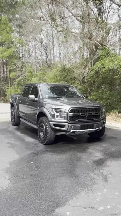 Mobile ceramic coating in Charleston, SC, detailer hand-applying a hydrophobic coating to a glossy car panel in an Old Village driveway near the harbor